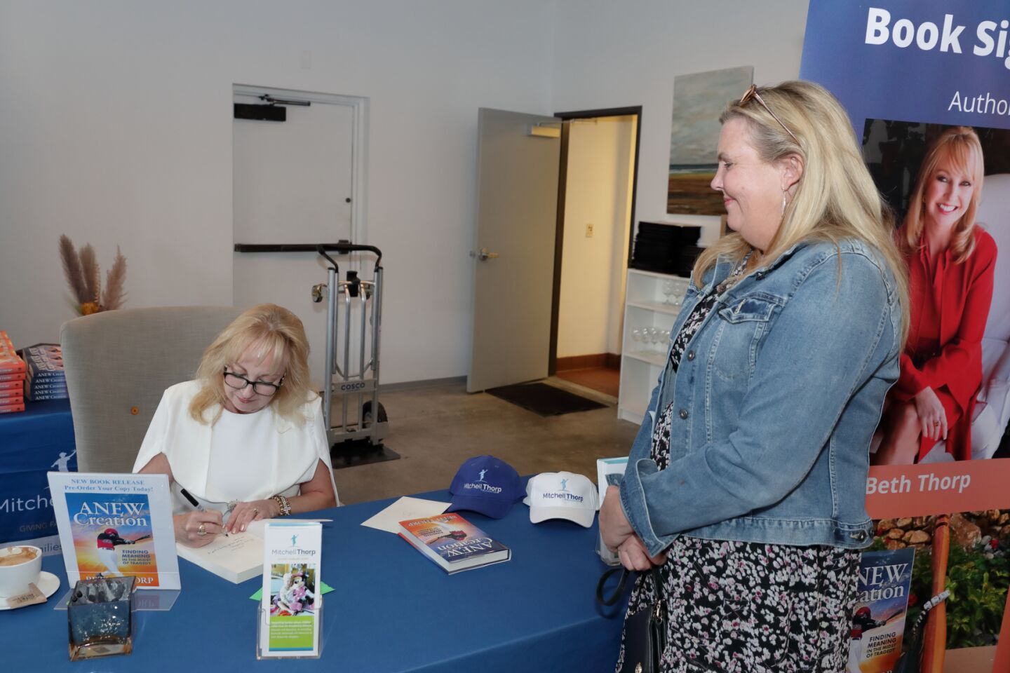 Beth Thorp signs a book for Barbara Alleway