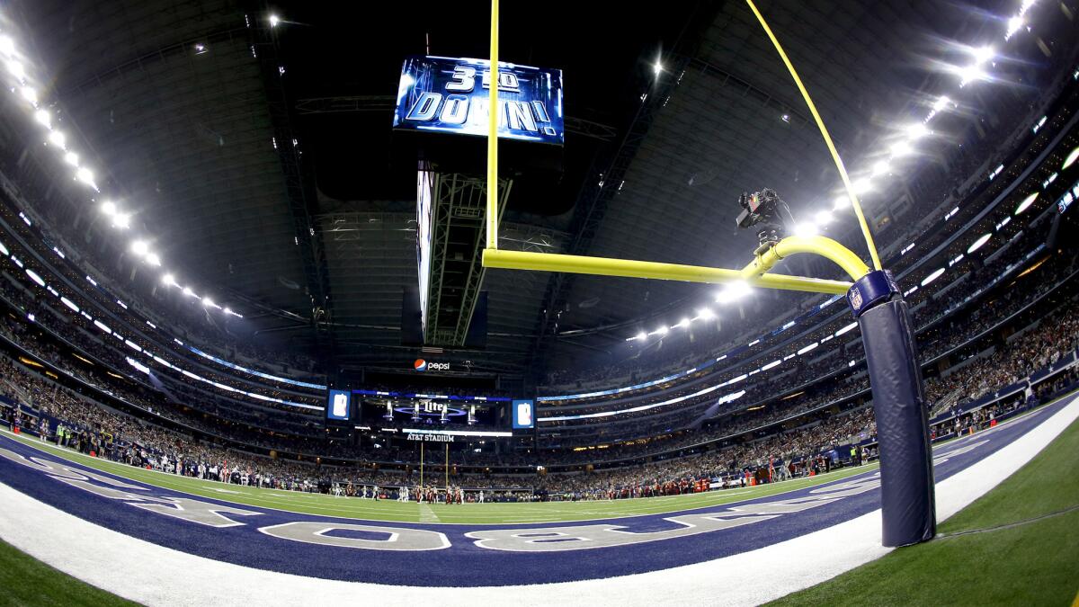 Cavernous AT&T Stadium, home of the Dallas Cowboys, features an artificial turf field.