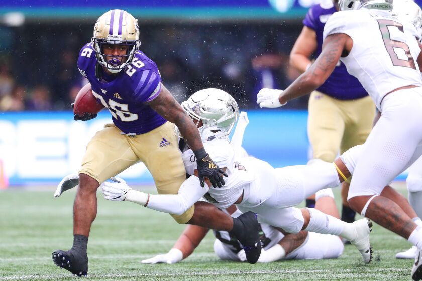SEATTLE, WASHINGTON - OCTOBER 19: Salvon Ahmed #26 of the Washington Huskies is tackled by Nick Pickett #16 of the Oregon Ducks in the first quarter during their game at Husky Stadium on October 19, 2019 in Seattle, Washington. (Photo by Abbie Parr/Getty Images) ** OUTS - ELSENT, FPG, CM - OUTS * NM, PH, VA if sourced by CT, LA or MoD **