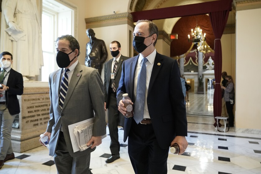 Rep. Jamie Raskin, D-Md., left, walks with Rep. Adam Schiff, D-Calif., at the Capitol in Washington, Wednesday, Jan. 13, 2021, as the House of Representatives pursues an article of impeachment against President Donald Trump for his role in inciting an angry mob to storm the Capitol last week. (AP Photo/J. Scott Applewhite)