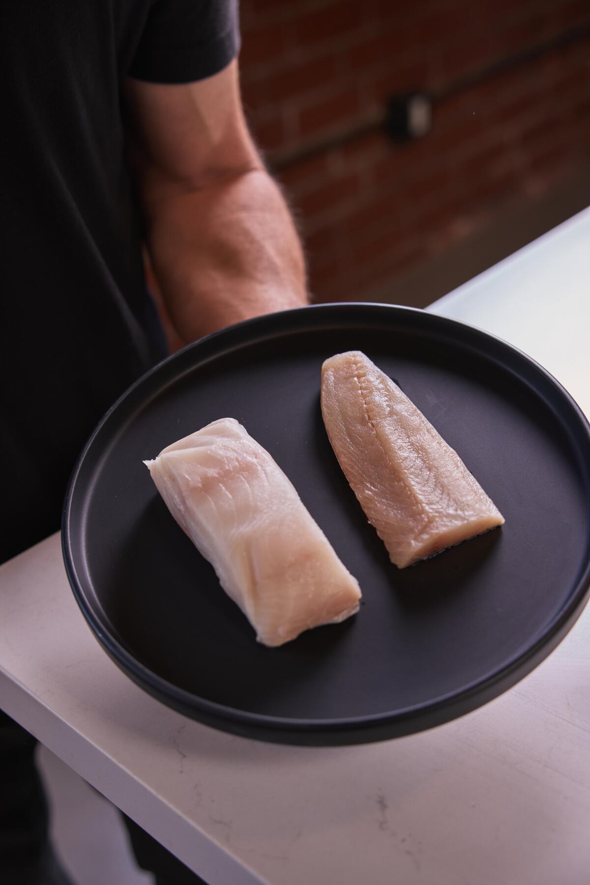 A Poseidon-processed fish fillet, left, sits next to a regular fish fillet.