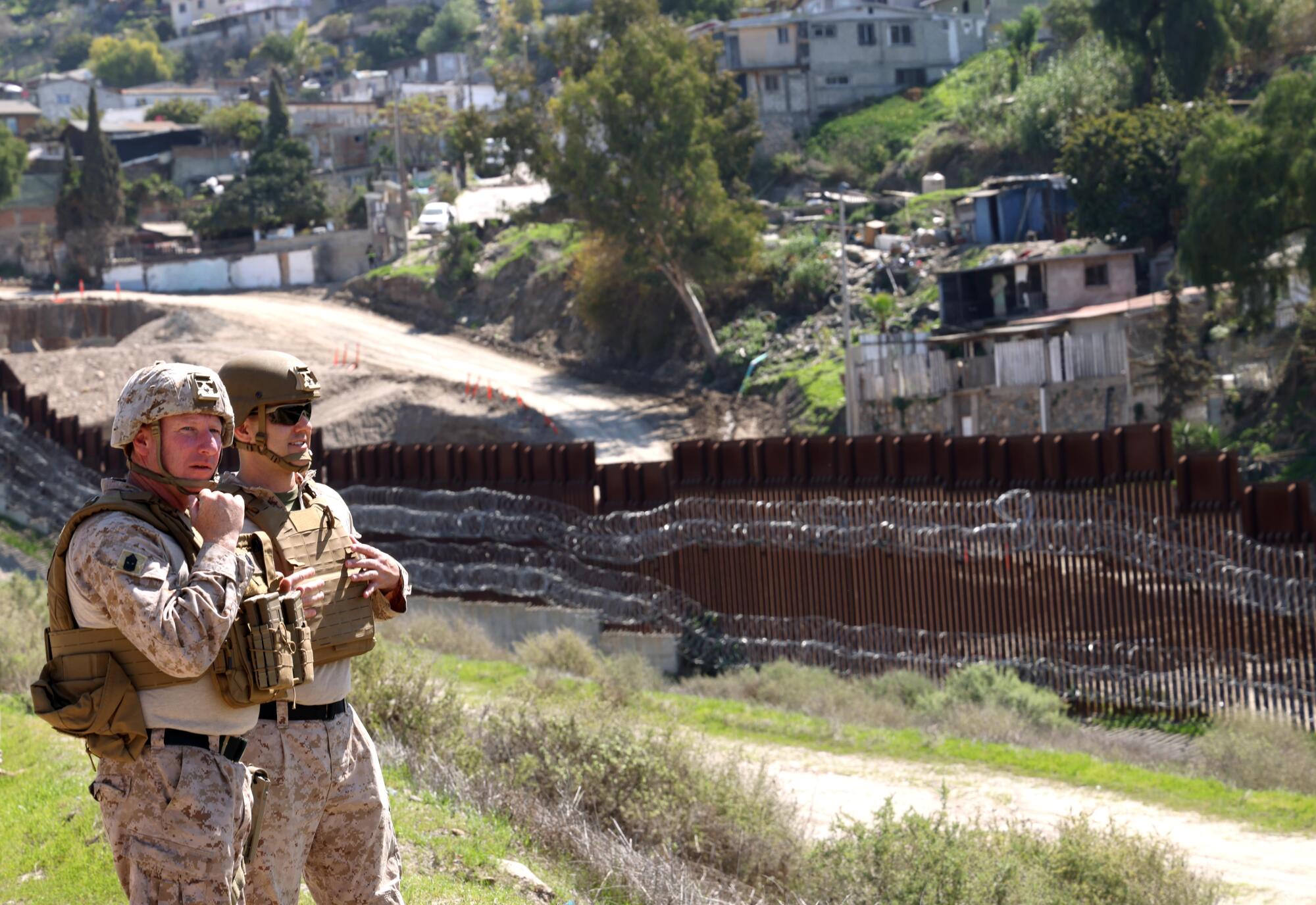 A pair of American soldiers looked at Tijuana, which was nestled behind the border wall and had a new hexagonal line near San Ysidro.