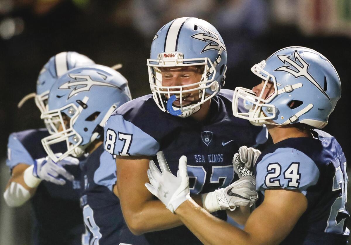 CdM tight end Scott Truninger (87) celebrates a touchdown with teammate Charlie Mannon (24).
