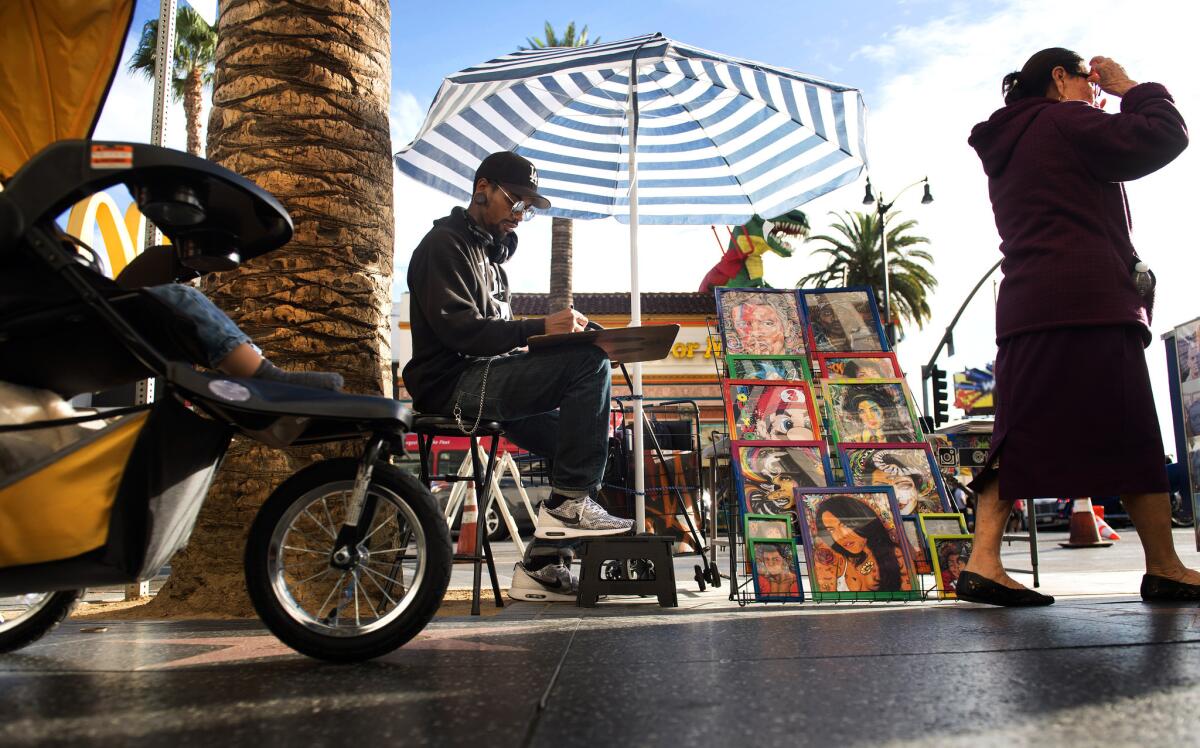 Christopher Stoute draws and sells his artwork on Hollywood Boulevard. Glendale City Council members are poised to adopt rules that will prohibit sidewalk vending, or street vending, in some of its busiest commercial areas.