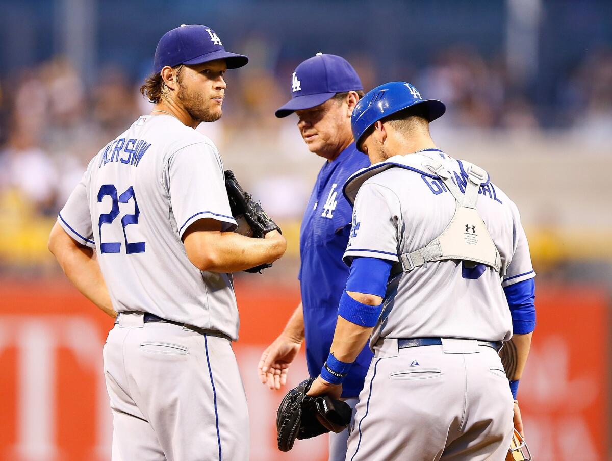 It just wasn't Dodgers starter Clayton Kershaw's day against the Pirates. He talks with pitching coach Rick Honeycutt and catcher Yasmani Grandal during a mound visit.