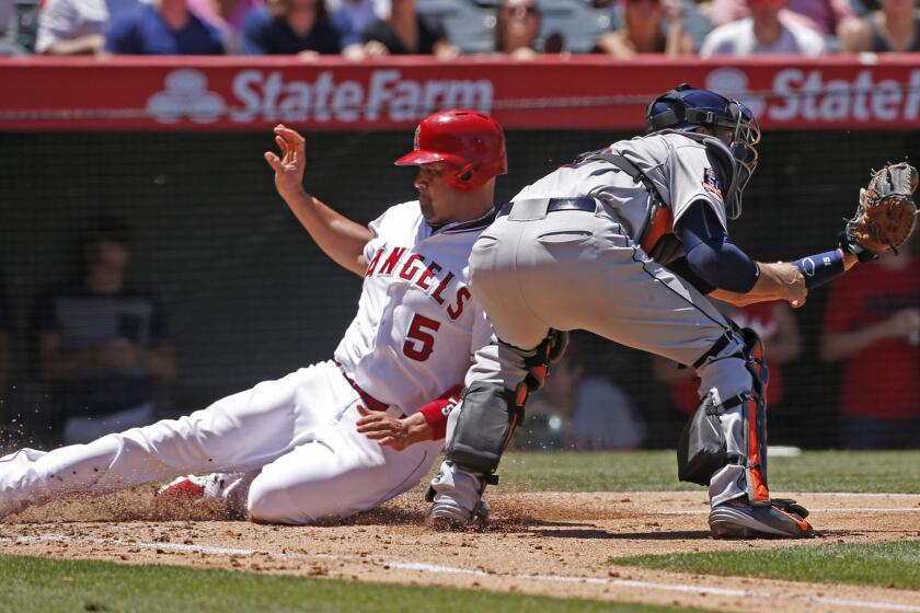 Angels first baseman Albert Pujols slides safetly into home on a sacrifice during the third inning of a game against the Houston Astros. The Angels beat the Astros, 2-1.