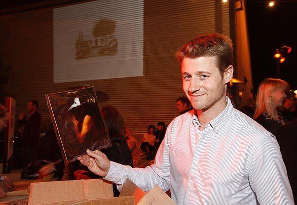 "Southland's" Ben McKenzie shows off one of his purchases at the Santa Monica Museum of Art's "Incognito" art sale.