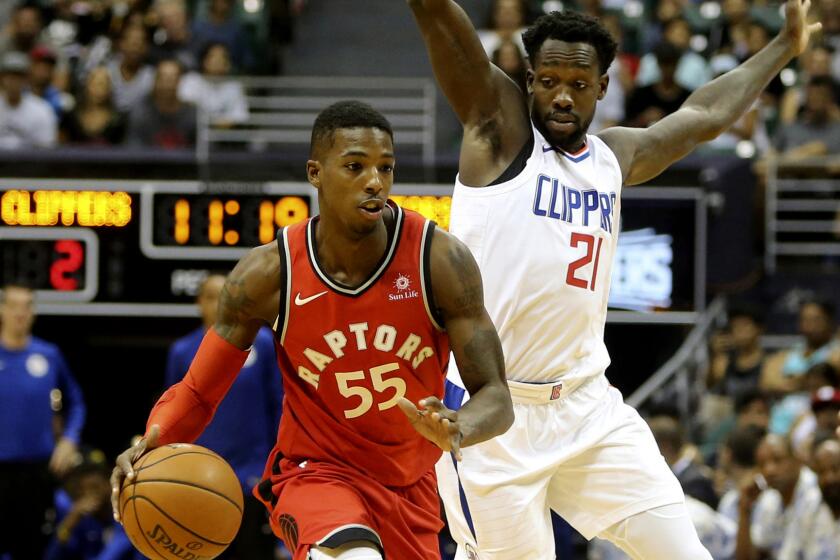 While being guarded by Los Angeles Clippers guard Patrick Beverley (21), Toronto Raptors guard Delon Wright (55) drives towards the basket during the first quarter of a preseason NBA basketball game, Tuesday, Oct. 3, 2017, in Honolulu. (AP Photo/Marco Garcia)