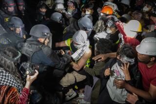 Los Angeles, CA - May 02: Demonstrators occupy a Pro-Palestinian encampment at UCLA as authorities breach and break up the encampment on Thursday, May 2, 2024 in Los Angeles, CA. (Jason Armond / Los Angeles Times)