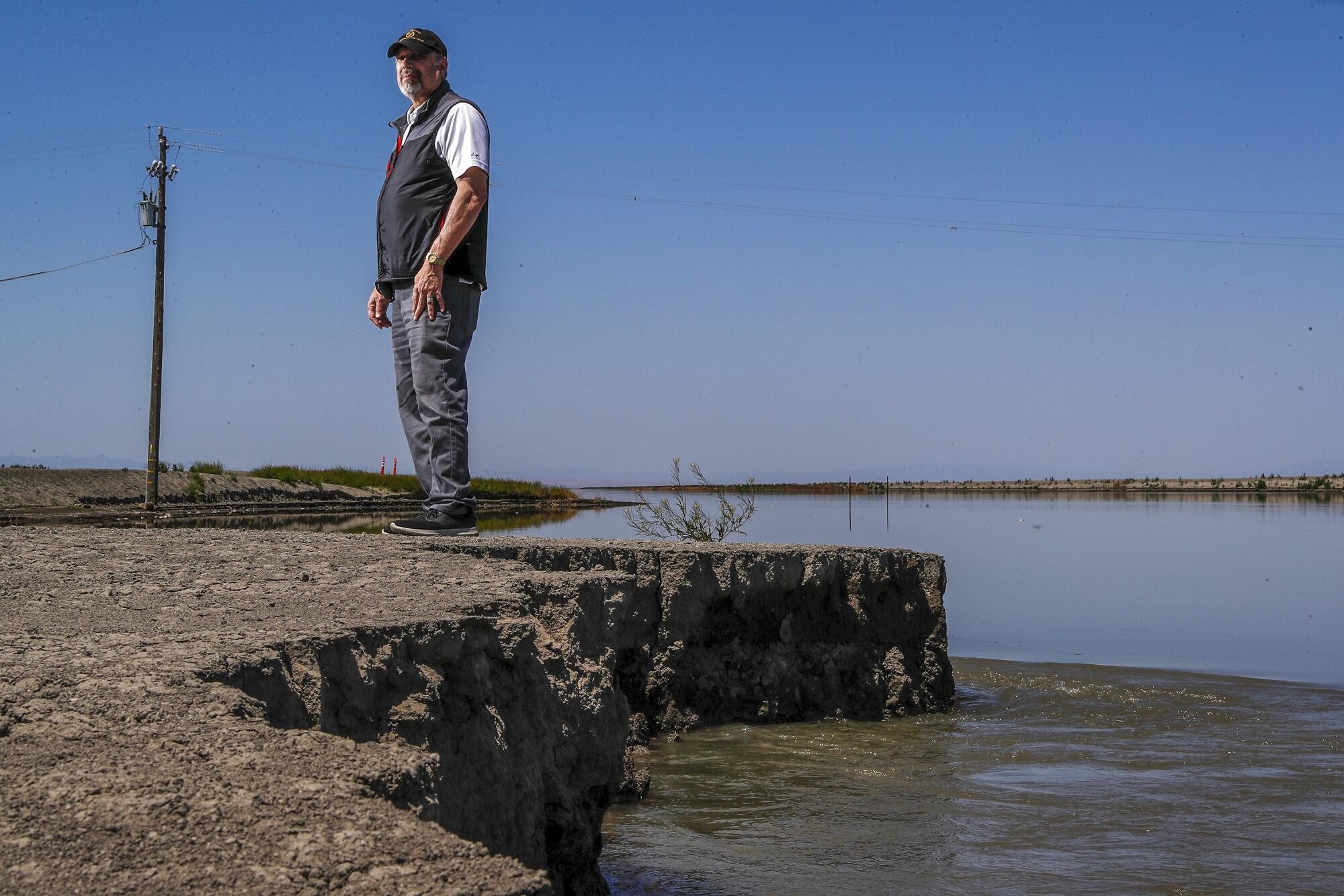 Mark Grewal, a veteran agricultural consultant, surveys a breached levee. 