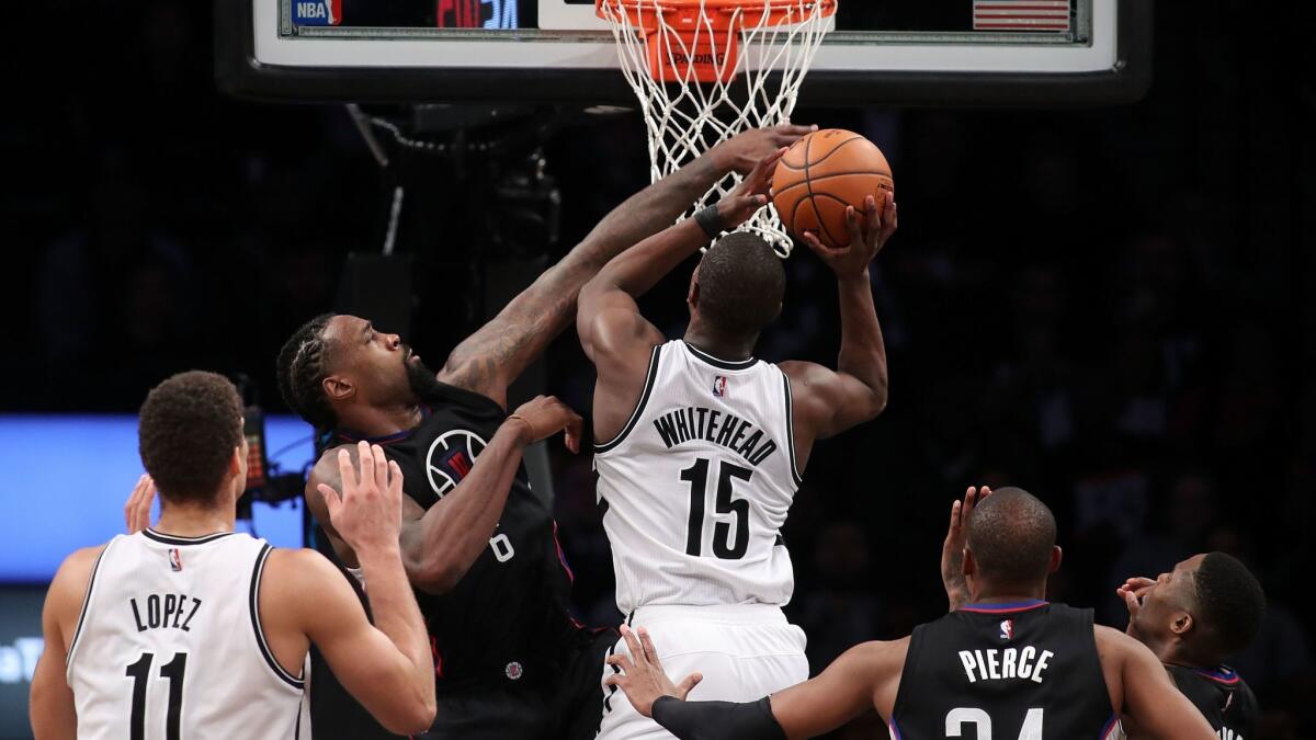 The Clippers' DeAndre Jordan defends as Brooklyn's Isaiah Whitehead puts up a shot on Tuesday.