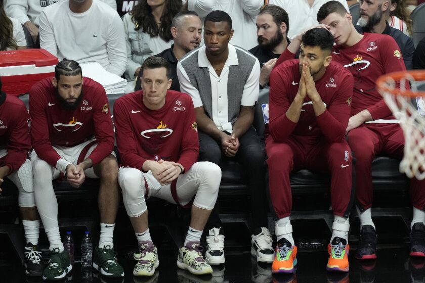 Miami Heat players react as they fall behind the Denver Nuggets during the second half of Game 3 of the NBA Finals basketball game, Wednesday, June 7, 2023, in Miami. (AP Photo/Rebecca Blackwell)