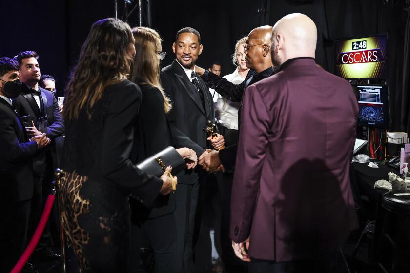 HOLLYWOOD, CA - March 27, 2022: Will Smith holds his Oscar for best actor for "King Richard" during the show at the 94th Academy Awards at the Dolby Theatre at Ovation Hollywood on Sunday, March 27, 2022. (Robert Gauthier / Los Angeles Times)