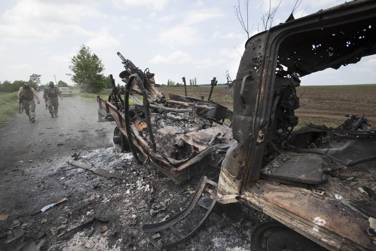 The charred remains of a Ukrainian military armored personnel carrier in the village of Oktyabrskoye, near Kramatorsk, on Wednesday. Six Ukrainian soldiers were killed in an ambush at the site by pro-Russia gunmen on Tuesday.