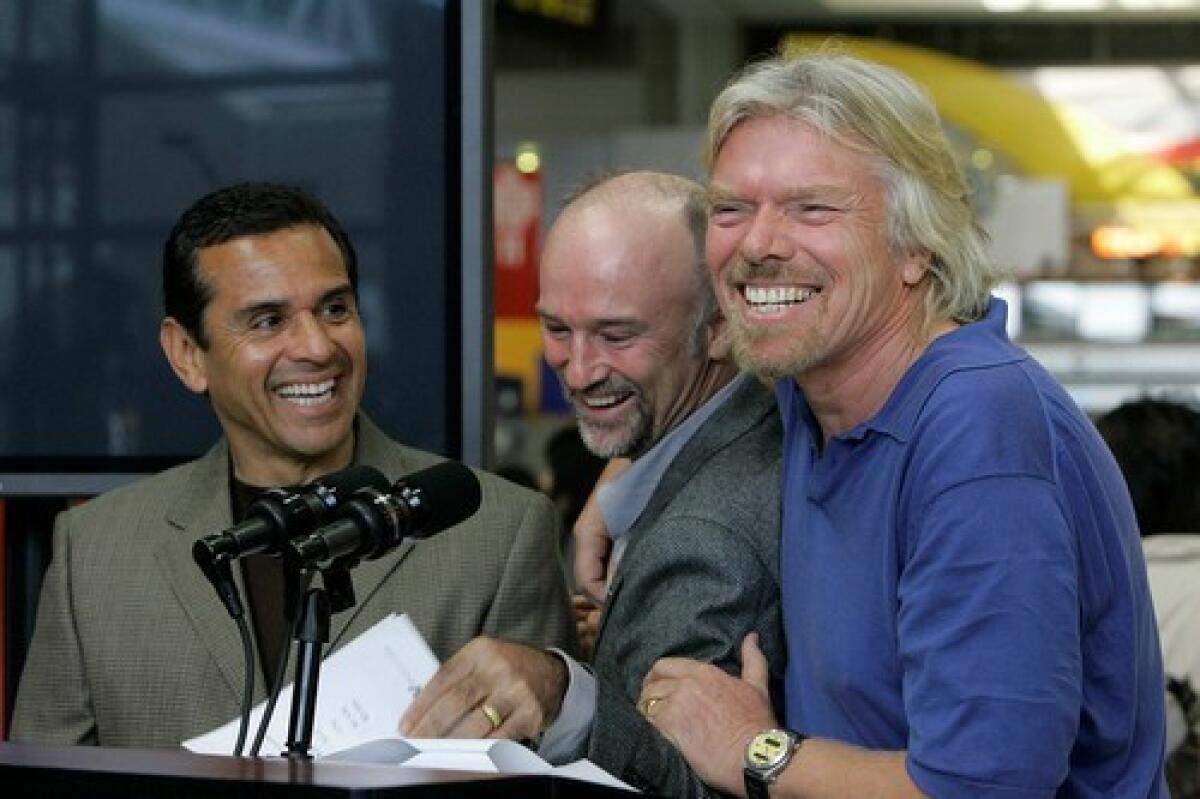 Virgin Group Chairman Richard Branson, from right, cuts up with Virgin Blue CEO Brett Godfrey and Los Angeles Mayor Antonio Villaraigosa at a Los Angeles International Airport news conference announcing the new transpacific service.