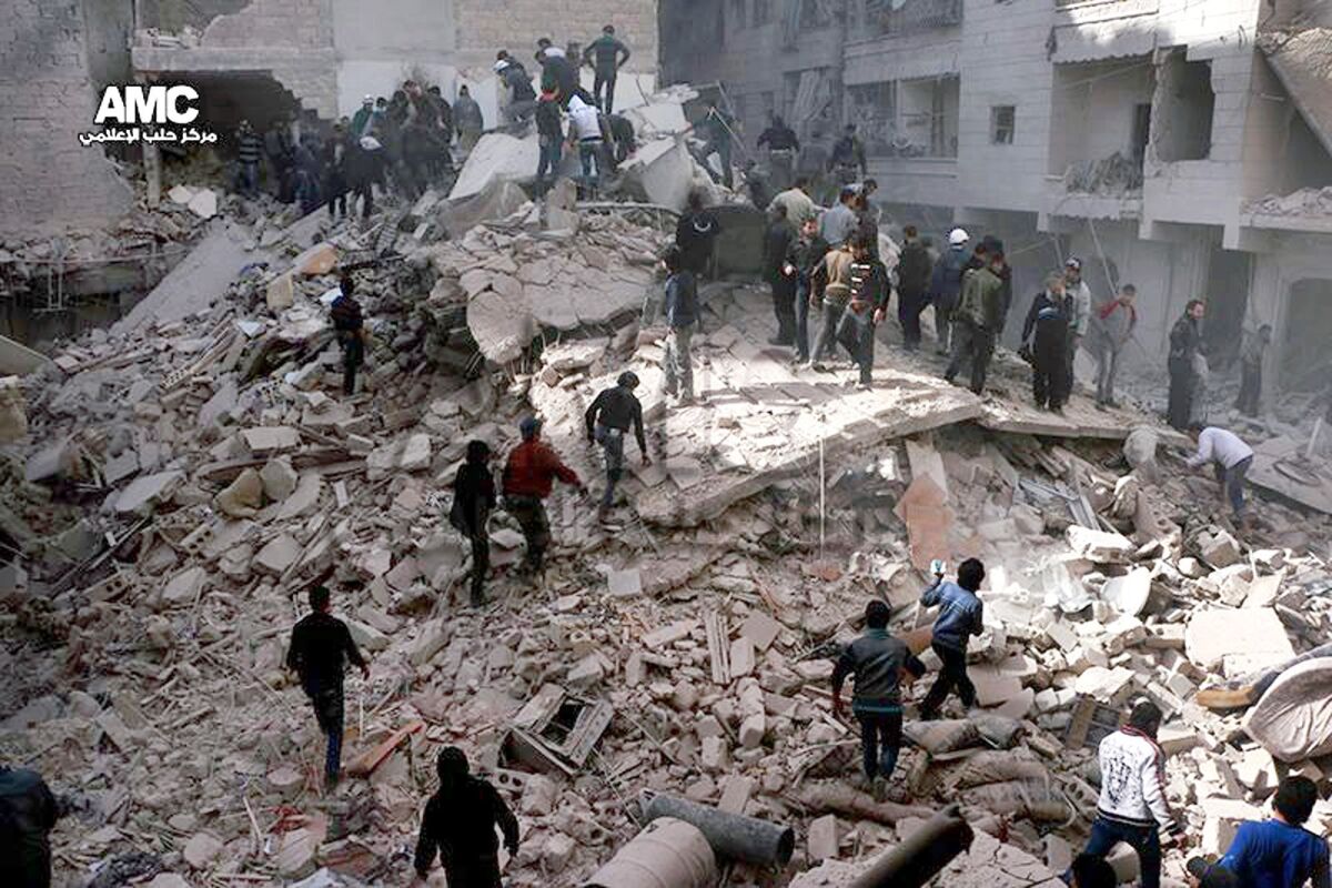 This picture taken on Wednesday provided by the anti-government activist group Aleppo Media Center, which has been authenticated based on its contents and other Associated Press reporting, shows Syrians inspecting the rubble of destroyed buildings following a Syrian government airstrike in Aleppo.