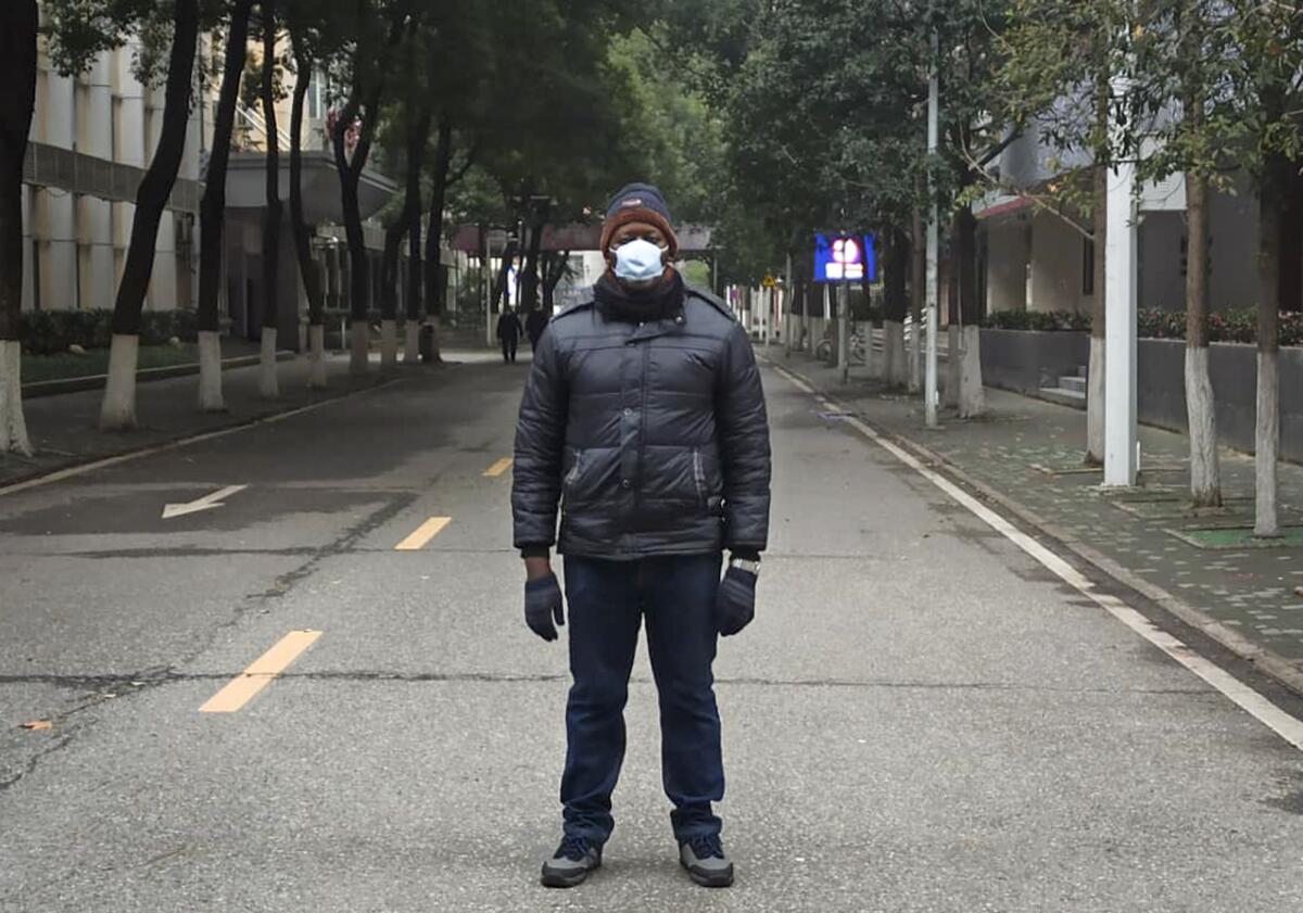 Khamis Hassan Bakari of Tanzania stands in a deserted street in Wuhan, China. Bakari is among more than 4,000 African students in the city of 11 million, which has been locked down by authorities trying to contain the coronavirus.