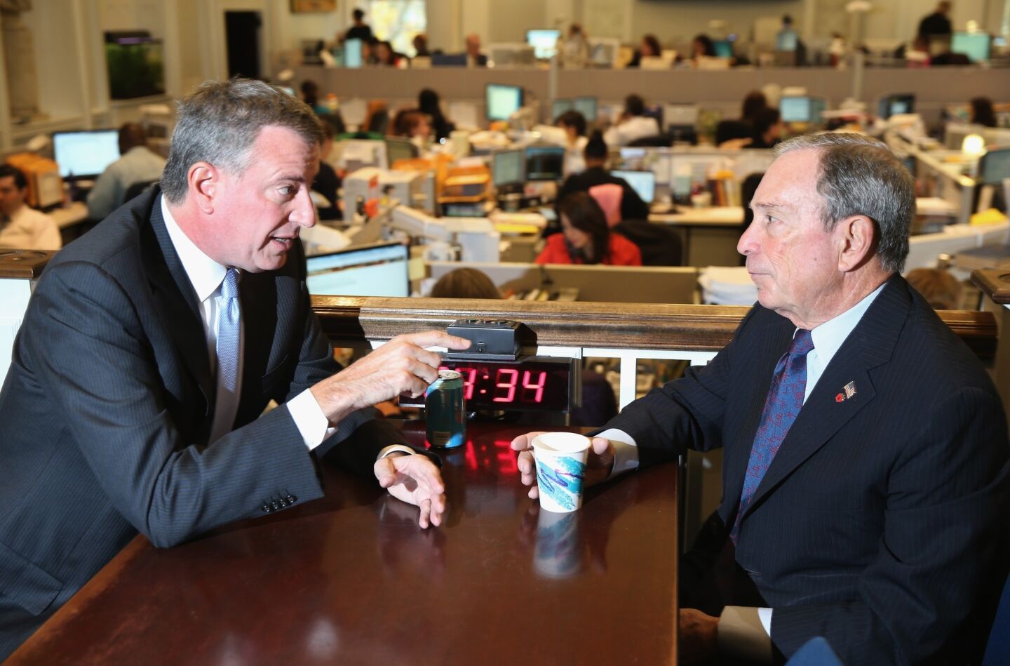 New York City Mayor-elect Bill de Blasio speaks with outgoing Mayor Michael Bloomberg at City Hall.