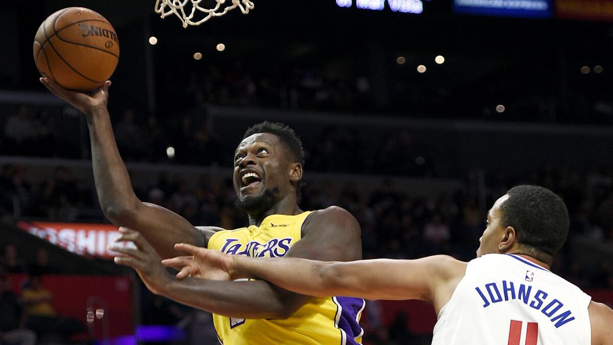 Lakers forward Julius Randle is fouled by Clippers forward Brice Johnson during the second half of their preseason game Saturday.