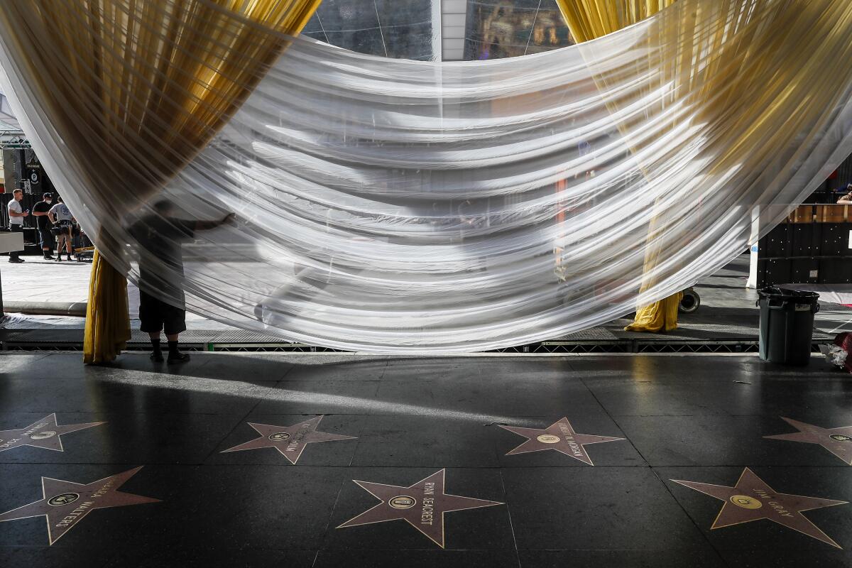 Crews construct the red carpet area at Ovation Hollywood days before the 94th Oscars at Dolby Theater. 