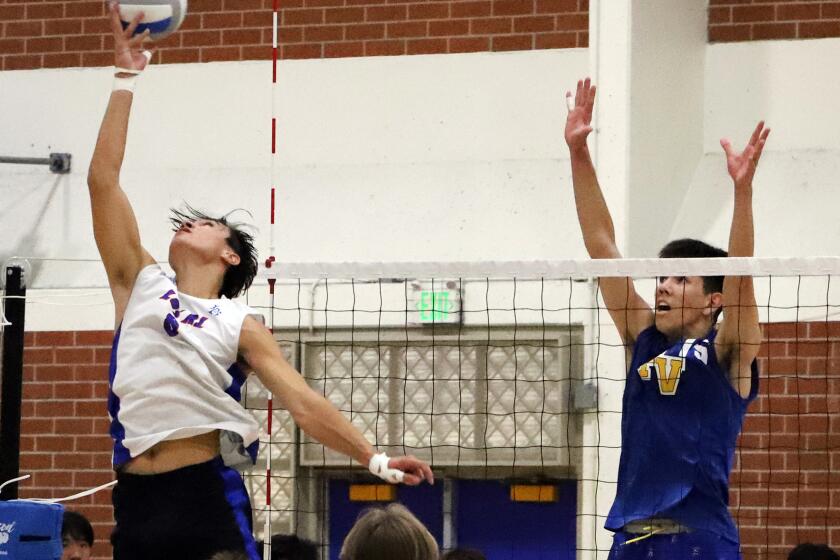 Los Alamitos Adrian Parra (9) does a backward shot for the score during Los Alamitos High School boys' volleyball team against Fountain Valley High School boys Volleyball team in the Wave League boys' volleyball match at Fountain Valley High School in Fountain Valley on Thursday, April 11, 2024. (Photo by James Carbone)