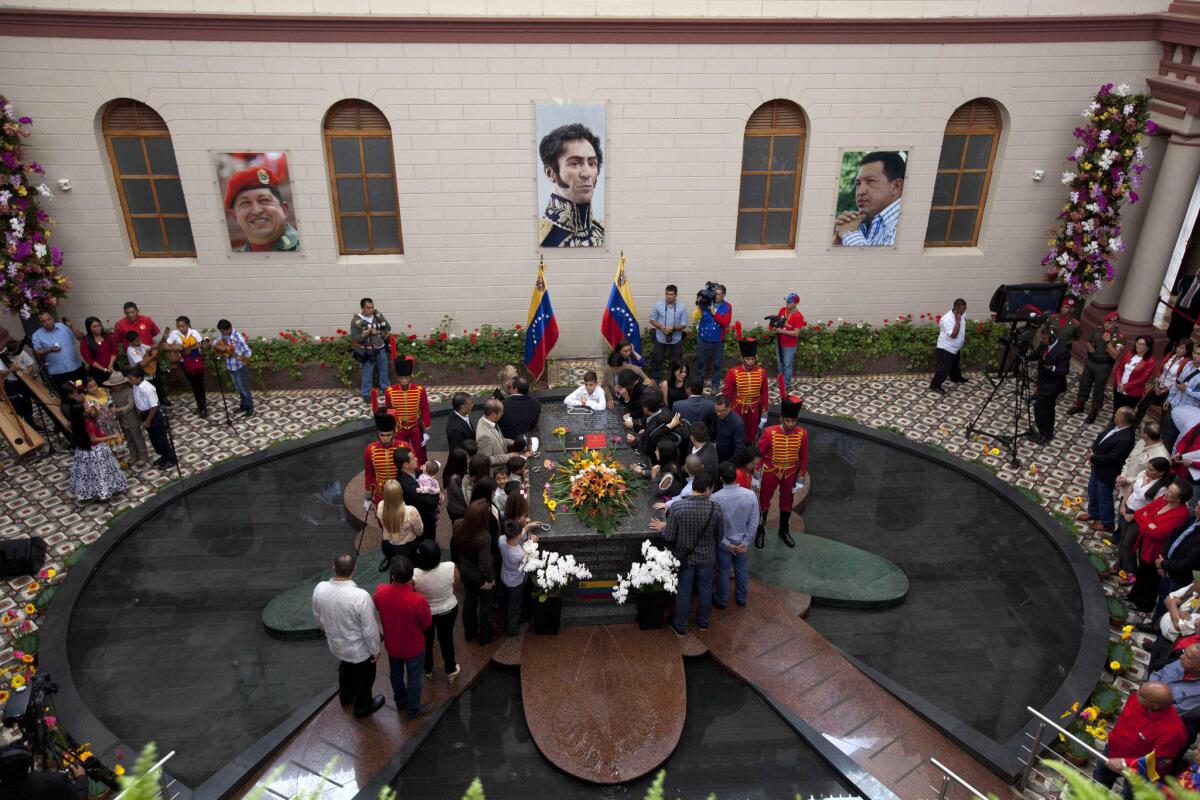 Relatives of the late Venezuelan president Hugo Chavez gather at his tomb in Caracas on March 5, the second anniversary of his death.