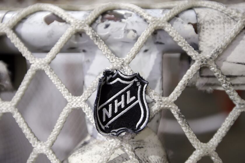 The NHL logo is seen on a goal at a Nashville Predators practice rink on Monday, Sept. 17, 2012, in Nashville, Tenn. The NHL locked out its players at midnight Saturday, the fourth shutdown for the NHL since 1992. (AP Photo/Mark Humphrey)