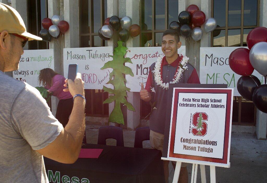 Costa Mesa High senior volleyball standout Mason Tufuga poses for his uncle Siopea Tufuga, left, before signing his intent to play for Stanford University.