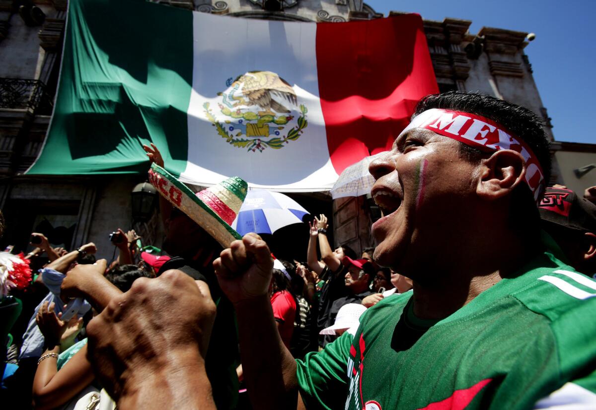 Rogelio Bobadilla shows his support for the Mexican soccer team during a watch party at Plaza Mexico in Lynwood.