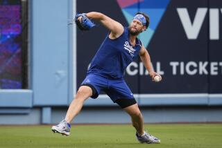 The Dodgers' Clayton Kershaw works out before a baseball game against the Colorado Rockies.