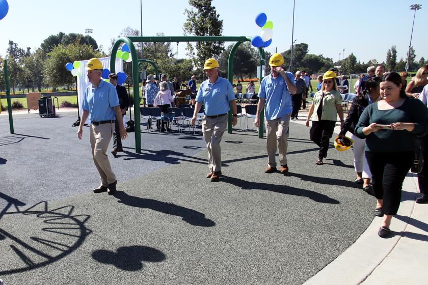 Fountain Valley Council Members, from left, Patrick Harper, Jim Cunneen, Vice Mayor Glenn Grandis and Fountain Valley Mayor Kim Constantine walk through the exciting playground that will be turned into a Universally Accessible Playground during the groundbreaking ceremony at the Fountain Valley Sports Park in Fountain Valley on Wednesday, October 4, 2023. (Photo by James Carbone)