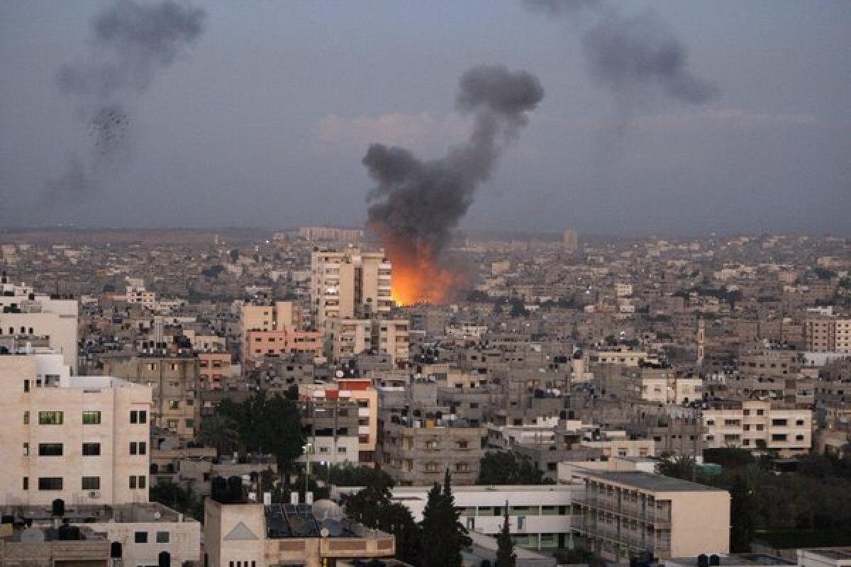 Columns of smoke rise following an Israeli air strike in Gaza City on Wednesday. Palestinian witnesses say Israeli airstrikes have hit a series of targets across Gaza City, shortly after the assassination of the top Hamas commander.