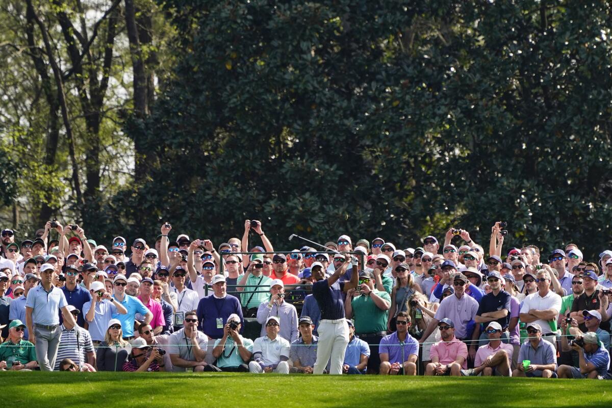 Tiger Woods tees off on the sixth hole during a practice round for the Masters golf tournament.