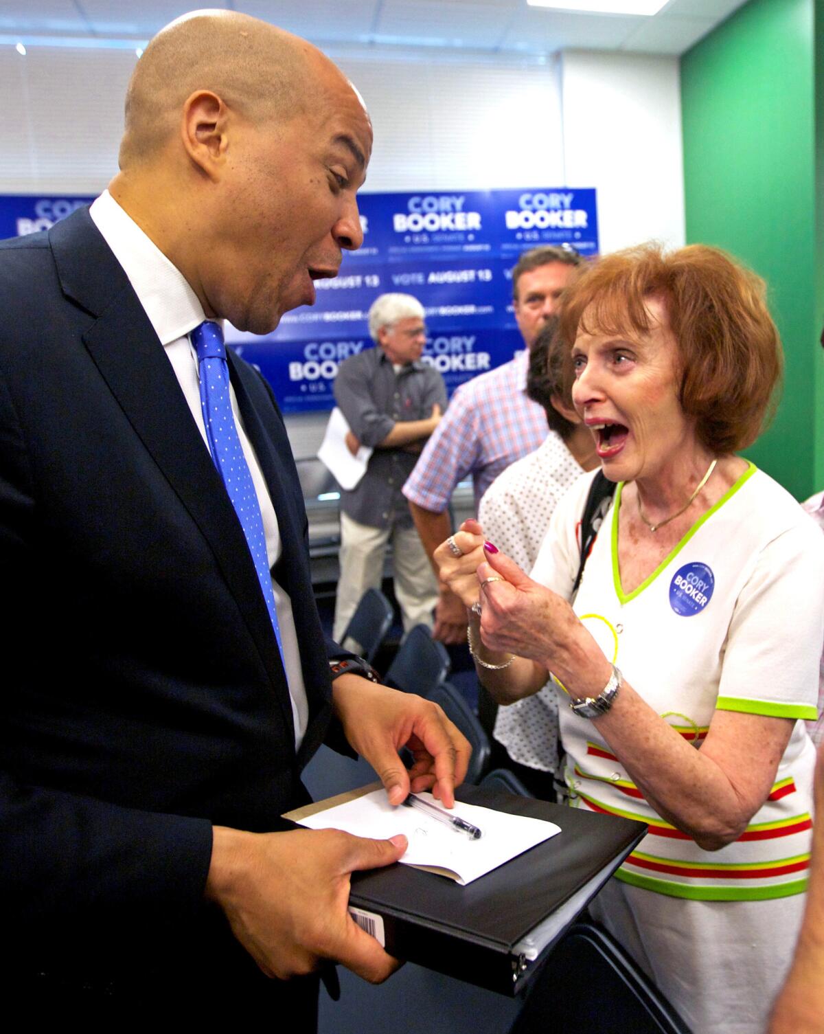 U.S. Senate candidate Cory Booker talks with Joyce Kemp, of Fair Lawn, N.J. after a campaign speech during the run-up to the primary.