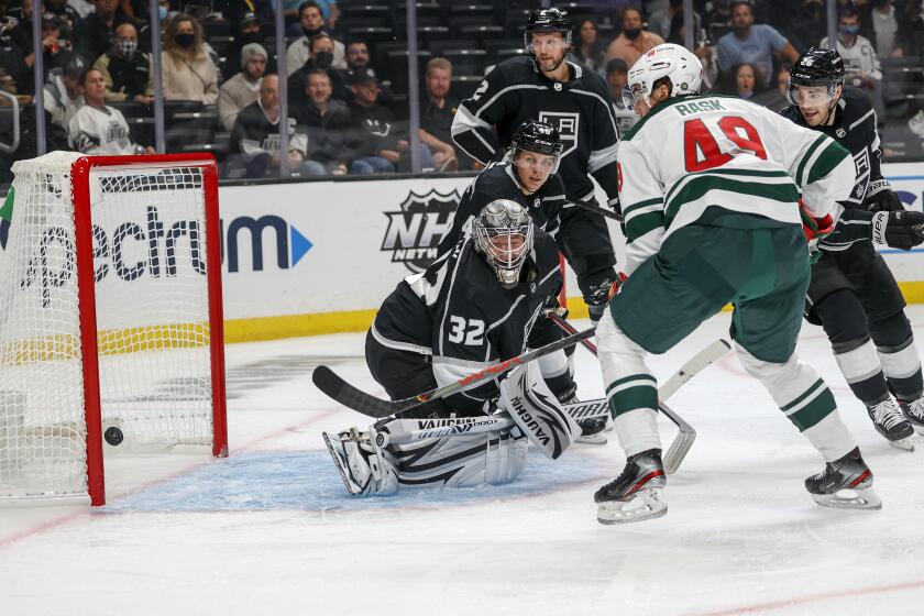 Kings goalie Jonathan Quick (32) gives up a goal to Wild forward Victor Rask (49) during the second period Oct. 16, 2021.
