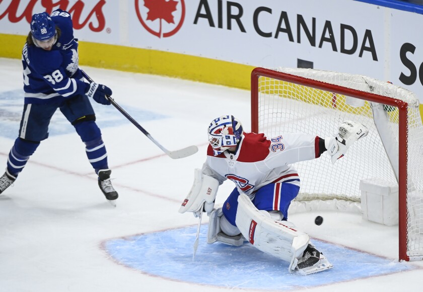 Toronto Maple Leafs forward William Nylander (88) scores past Montreal Canadiens goaltender Jake Allen (34) during the second period of an NHL hockey game Saturday, May 8, 2021, in Toronto. (Nathan Denette/The Canadian Press via AP)
