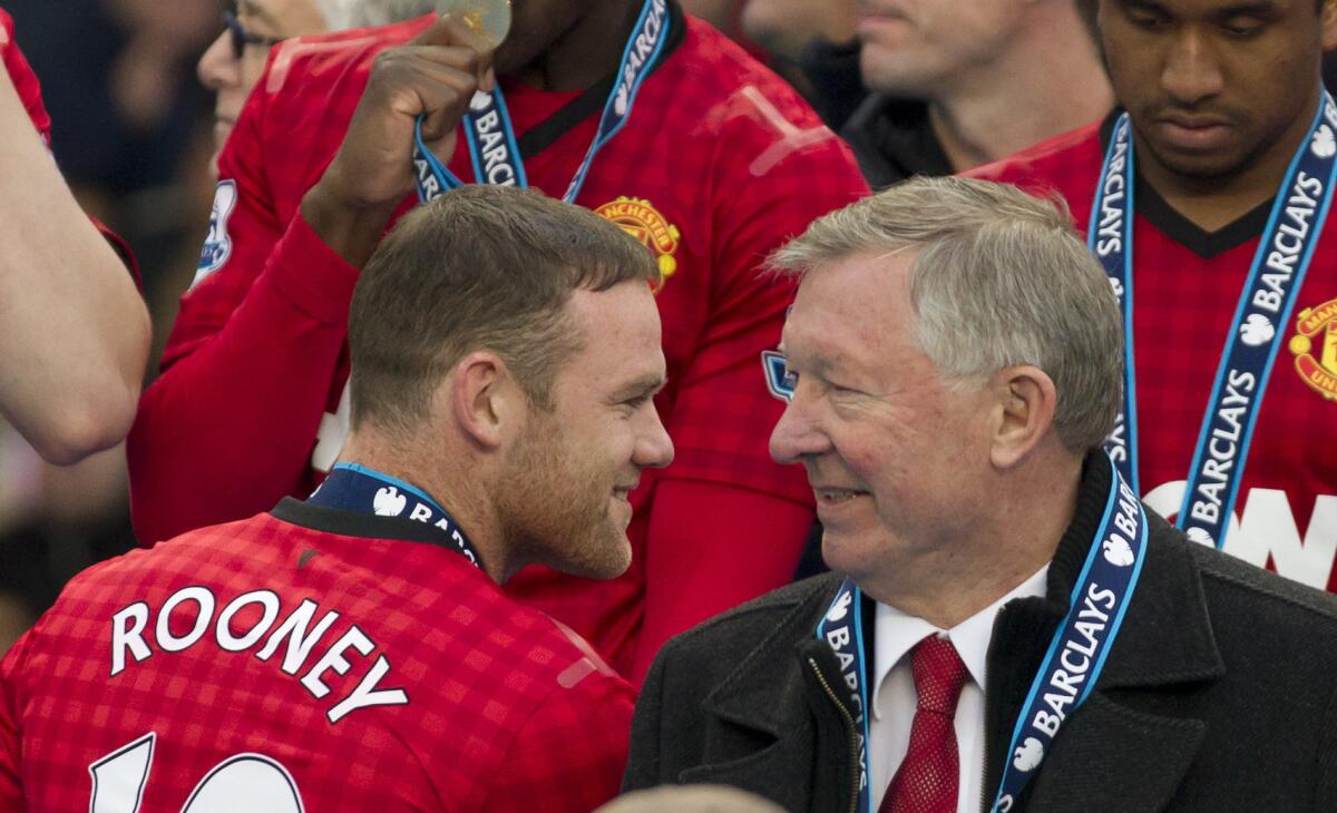 Manchester United Manager Sir Alex Ferguson talks to striker Wayne Rooney after his last home game in charge of the soccer club on Sunday at Old Trattford stadium.
