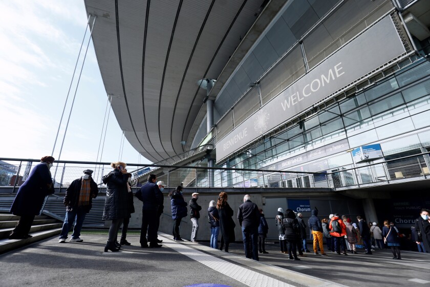 People arrive at the Stade de France stadium to be vaccinated against Covid-19 in Saint-Denis, outside Paris, Tuesday, April 6, 2021. While France remains far behind Britain and the United States in terms of vaccinating its population, the pace is starting to pick up. (Thomas Samson, Pool via AP)