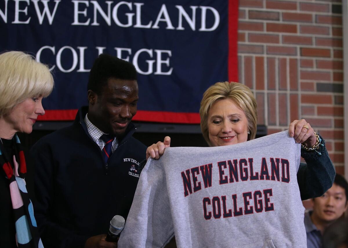 Former secretary of State Hillary Clinton receives a sweatshirt during a student town hall meeting at New England College Saturday in Henniker, N.H.