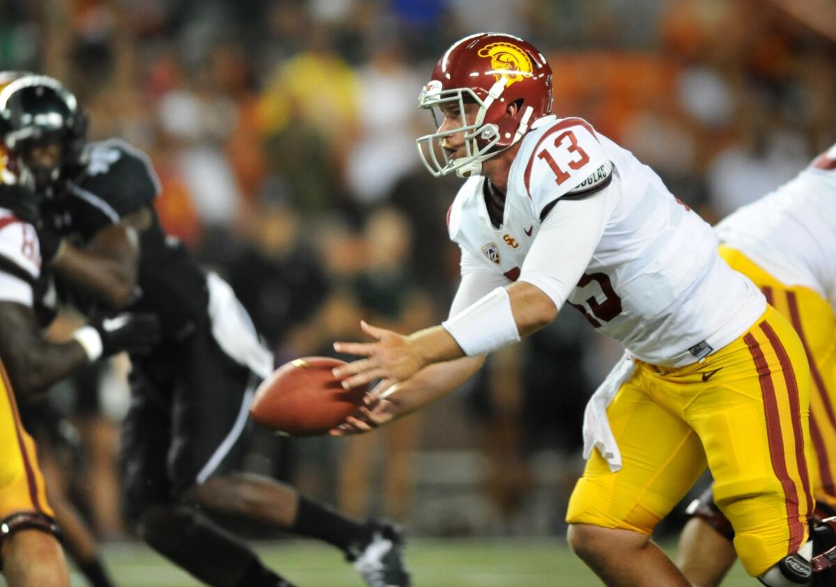 Trojans quarterback Max Wittek prepares to make a hand off during the third quarter of a 2013 game against Hawaii at Aloha Stadium.