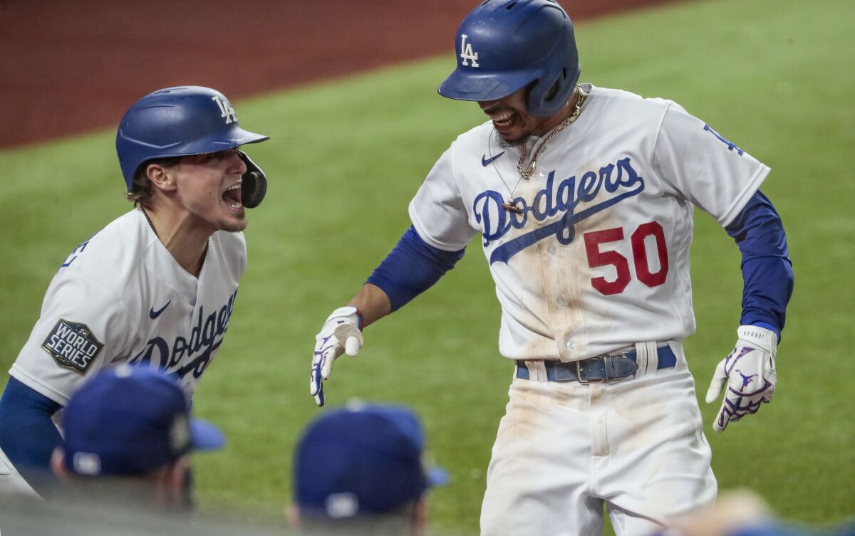 Dodgers' Mookie Betts is congratulated by teammate Kiké Hernandez after homering.
