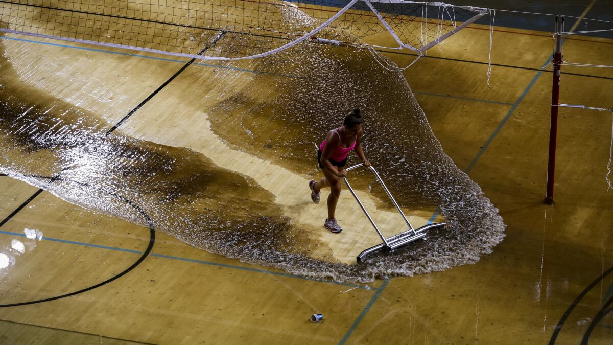Water is removed from the floor of Pauley Pavilion on the UCLA campus following Tuesday's flood caused by a broken water main underneath Sunset Boulevard.