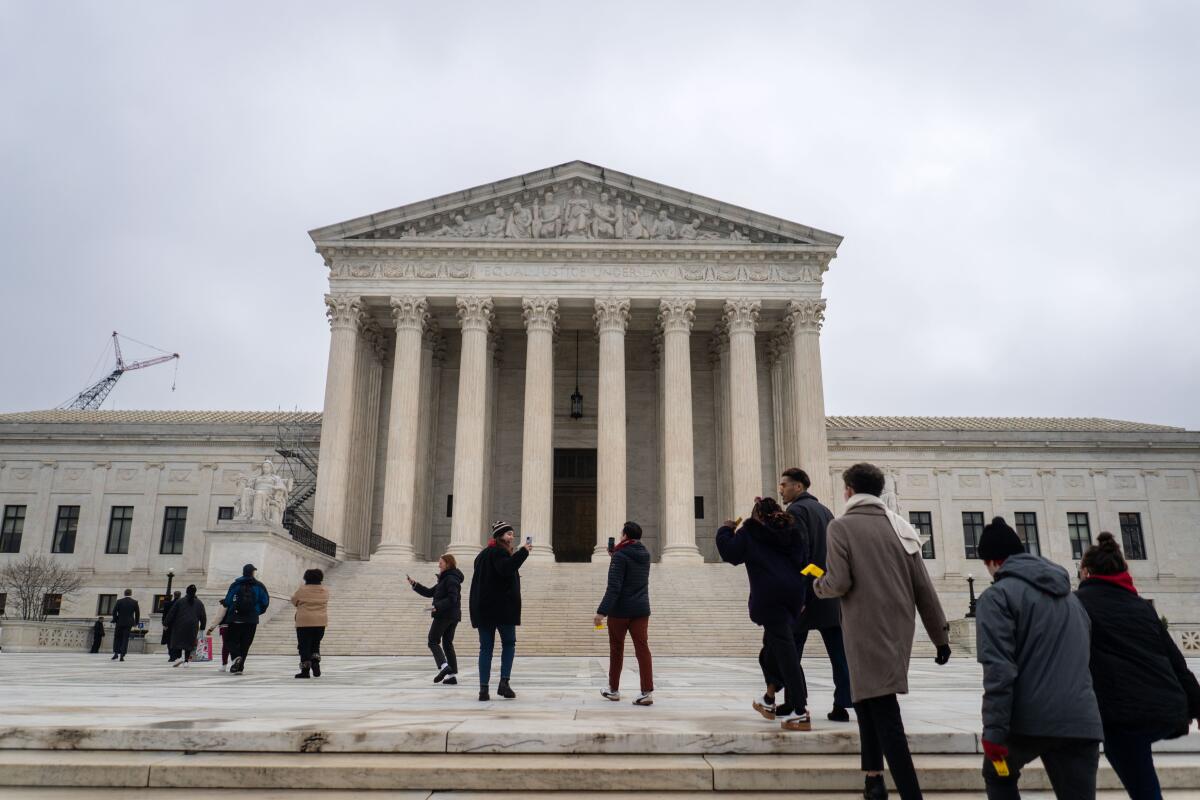 People wait in line outside the U.S. Supreme Court.