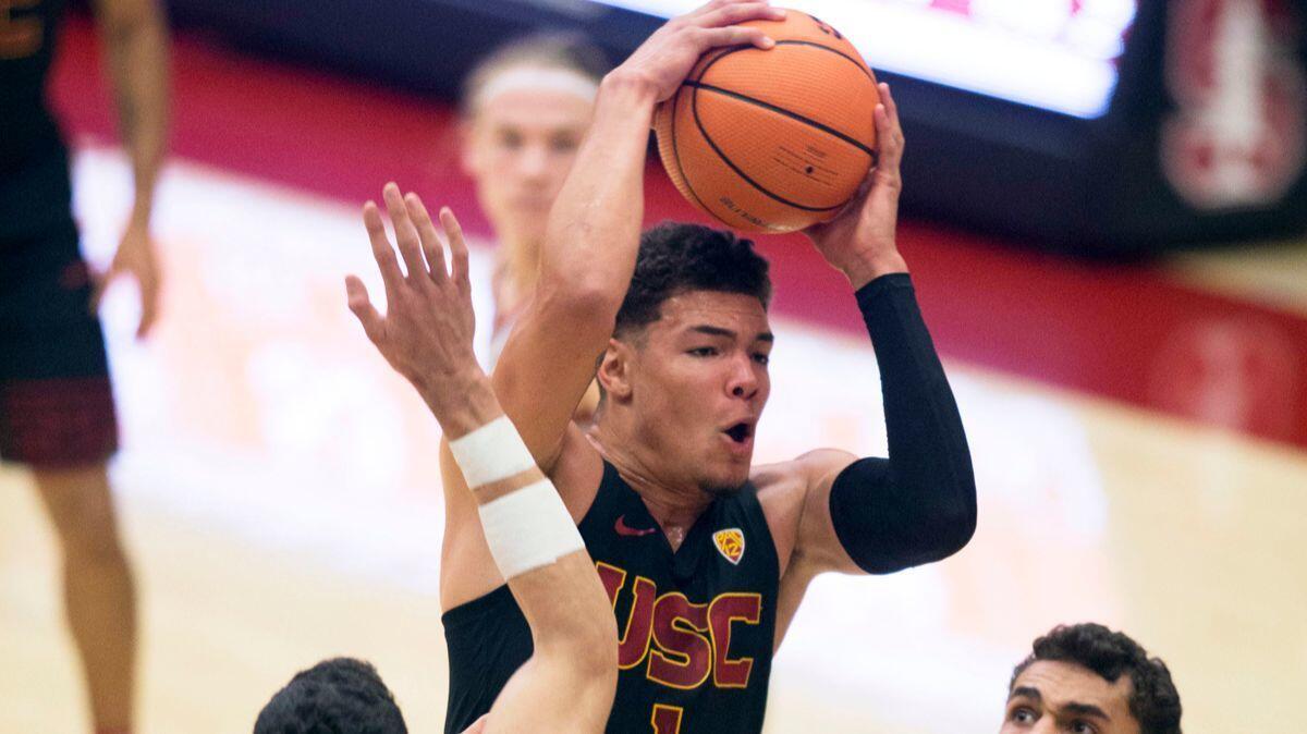 USC's Jordan Ushe drives to the basket between Stanford defenders during the second half on Sunday.