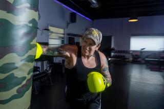 Candace Hansen, 39, punches a boxing bag at Everybody Gym.