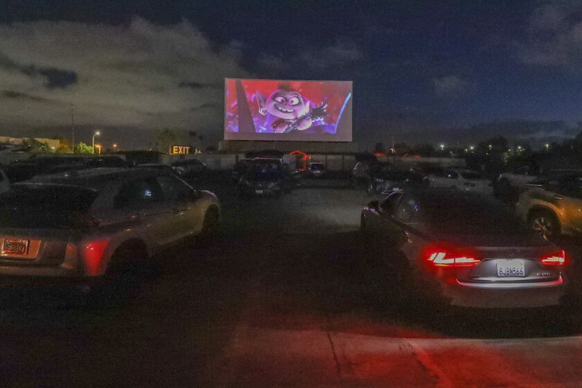 Cars are parked as people watch the movie "Trolls" at the South Bay Drive-In Theaters, which reopened last weekend, on May 13, 2020 in San Diego, California.