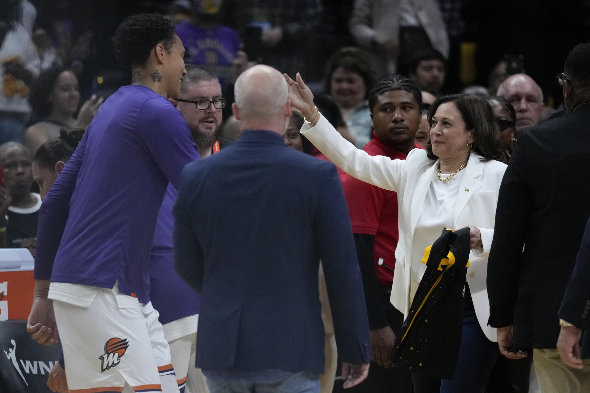 Phoenix Mercury center Brittney Griner is greeted by Vice President Kamala Harris and leans forward for a hug.