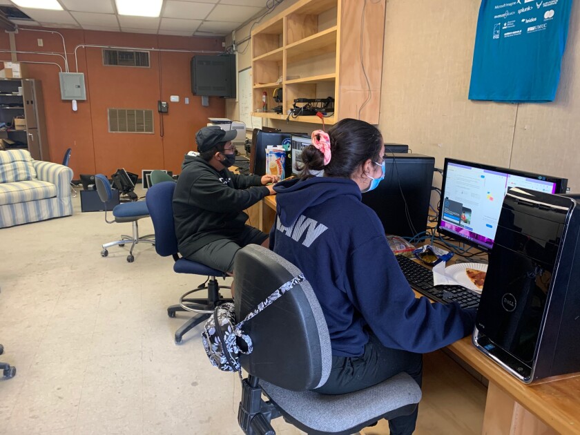 Cadets Leo Dinero and Hazel Galindo work their individual missions to support NJROTC's CyberPatriot team.