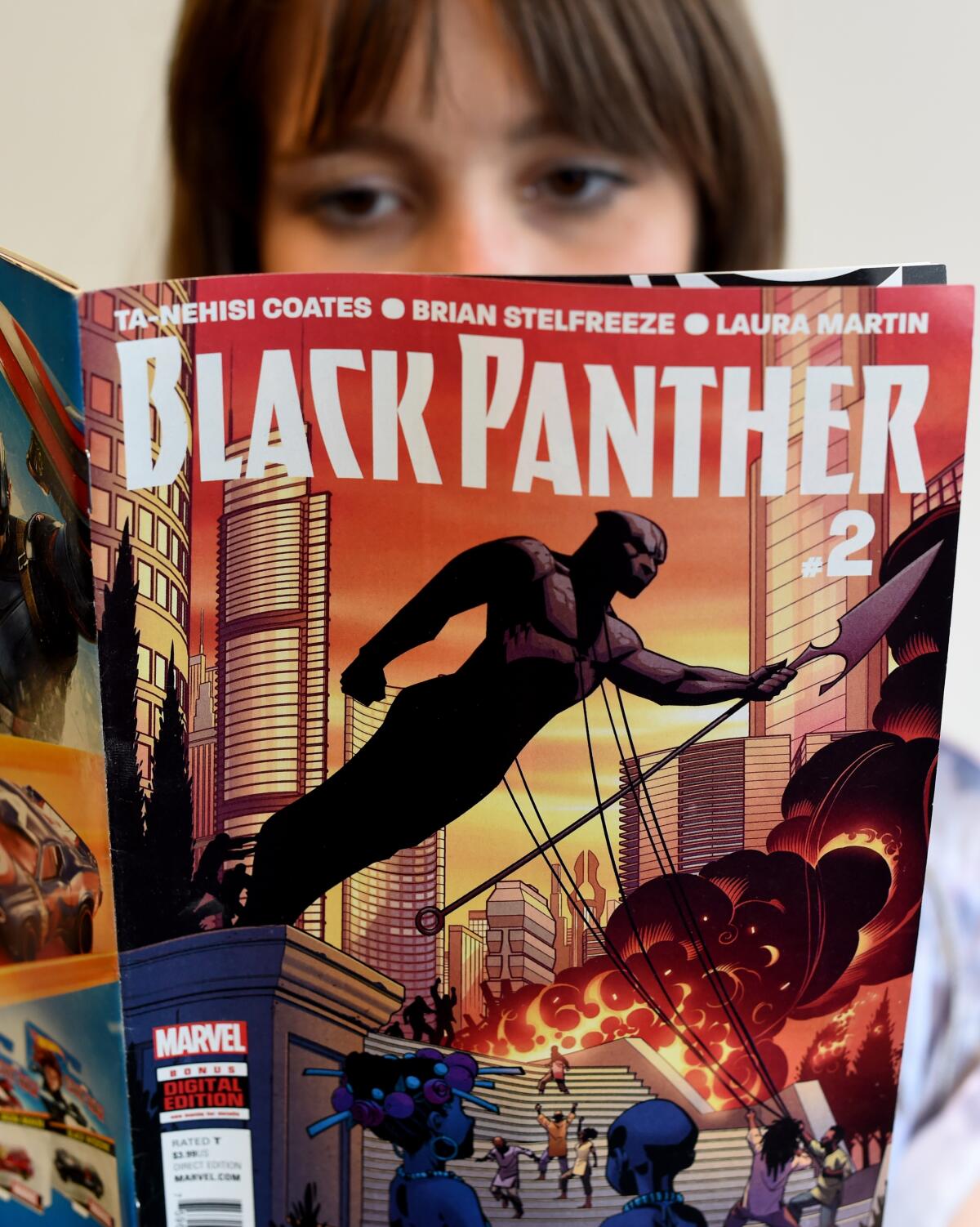 A woman reads the comic "Black Panther"