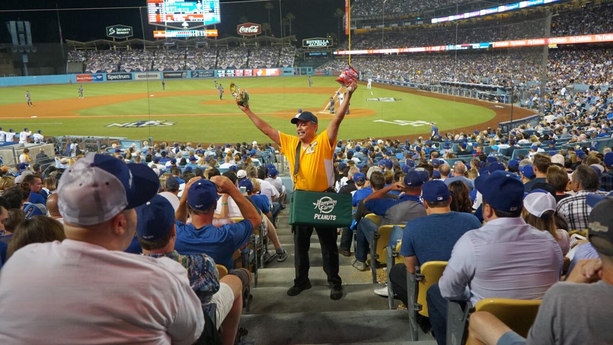Robert E. Sanchez sells peanuts and Cracker Jack during the 2017 National League Division Series at Dodger Stadium.